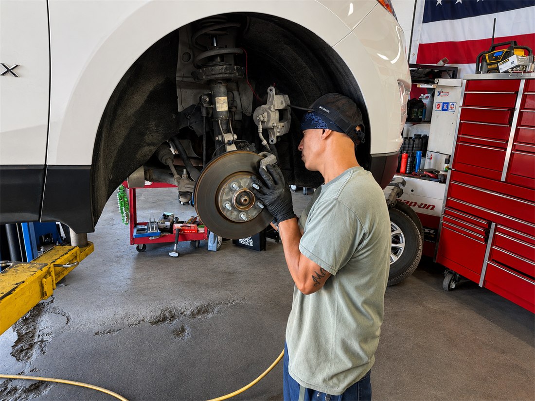 Brake and suspension work being performed on a vehicle on the lift
