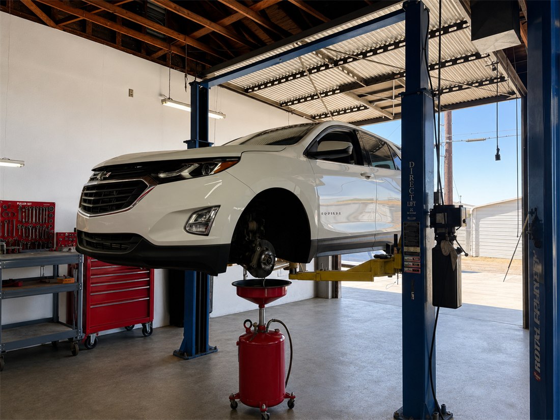 A vehicle up on the lift at Big Rob's Automotive with an oil drain pan positioned underneath for an oil change